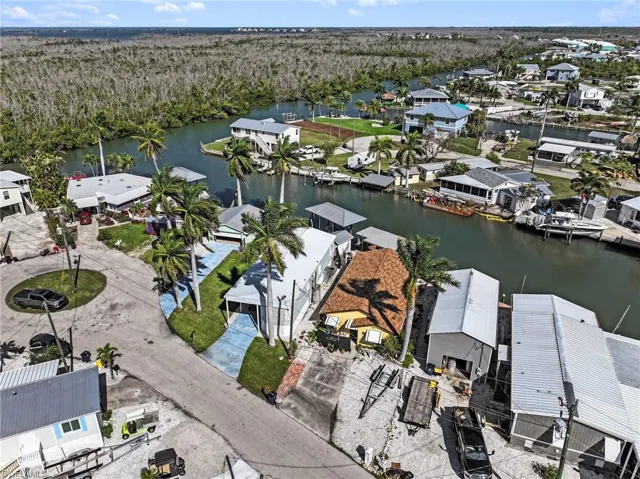 Aerial view of residential area featuring a nearby body of water