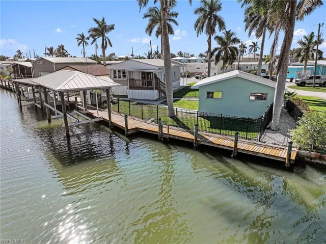 Dock area with a water view and boat lift