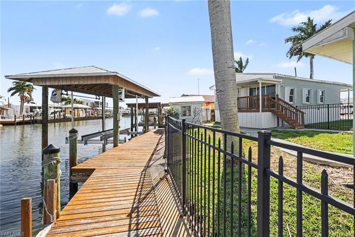 Dock area featuring a water view and boat lift