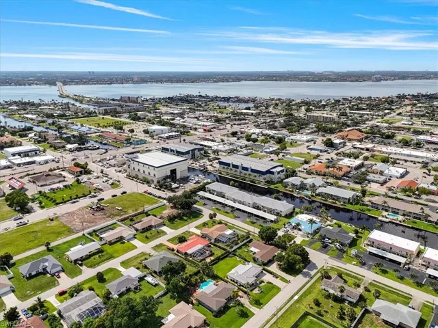 Aerial perspective of suburban area featuring a large body of water