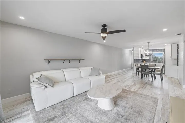 Bedroom with light carpet and a ceiling fan
