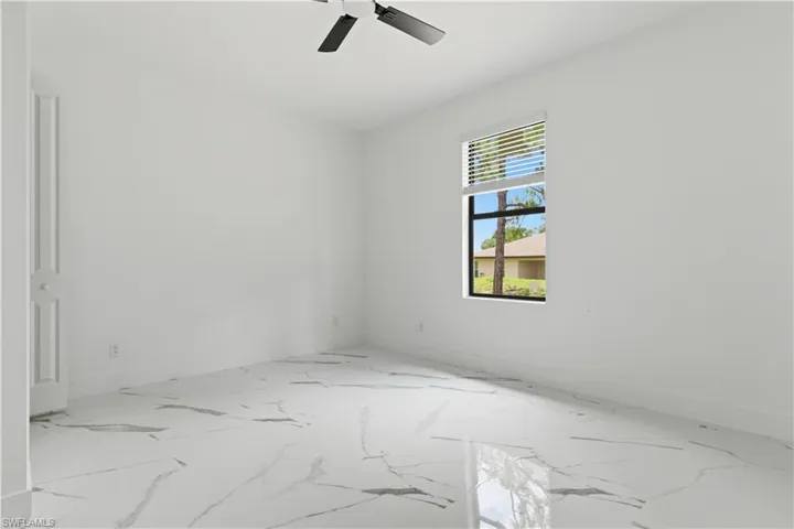 Bright interior space featuring large format marble-look tile flooring