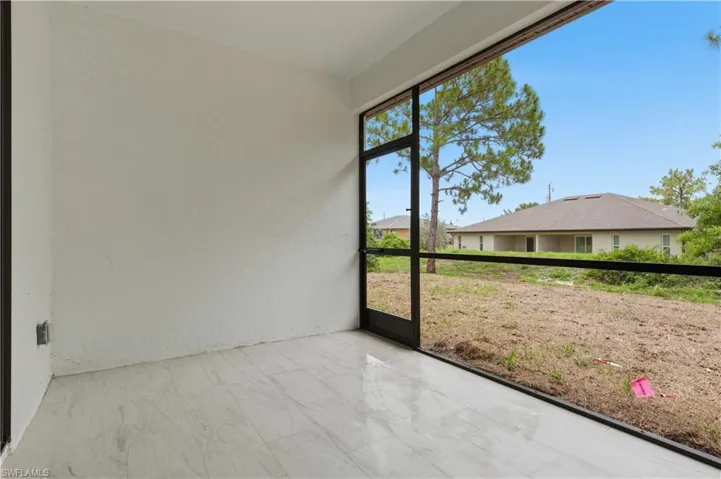 Screened patio featuring light-toned tile flooring and a textured wall finish