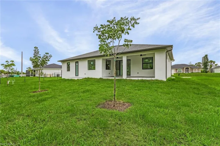 Back of property with a yard