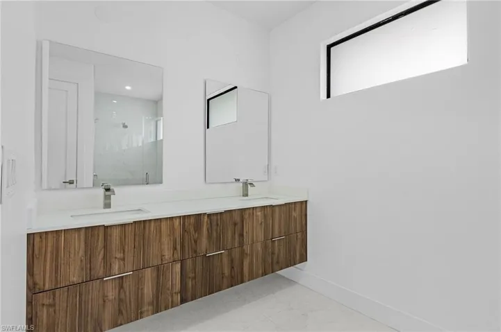 Bathroom with double vanity and tile patterned floors