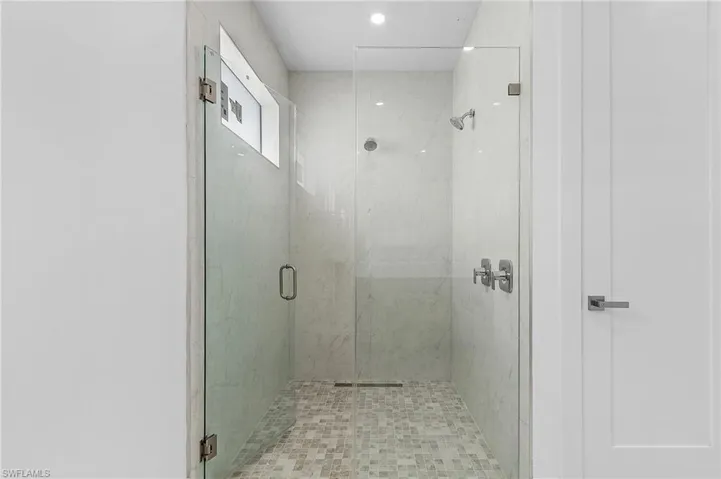 Bathroom featuring a shower with door