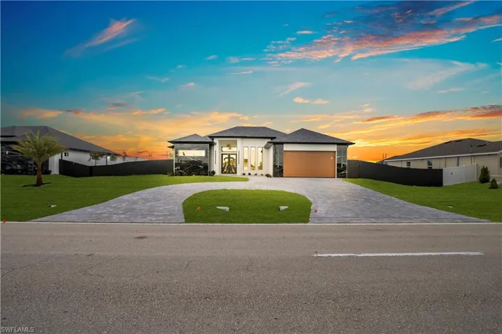Prairie-style house with curved driveway and a garage
