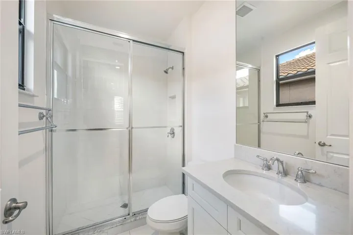 Bathroom with a stall shower and vanity