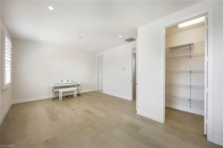 Walk in closet featuring light wood-style floors
