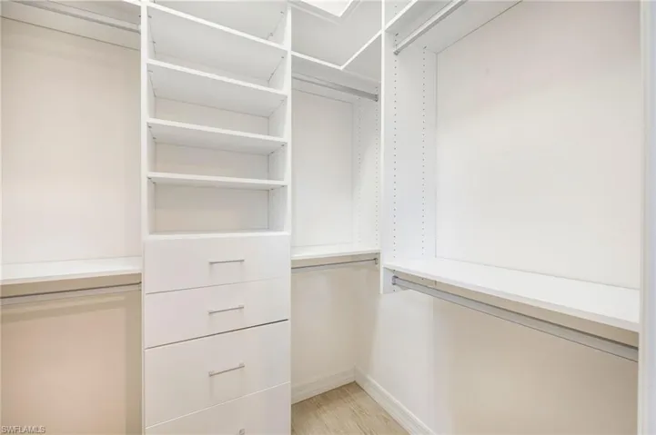 Laundry room with independent washer and dryer and light tile patterned floors