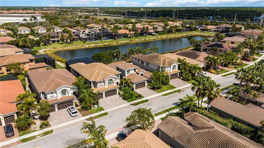 Aerial perspective of suburban area featuring a nearby body of water