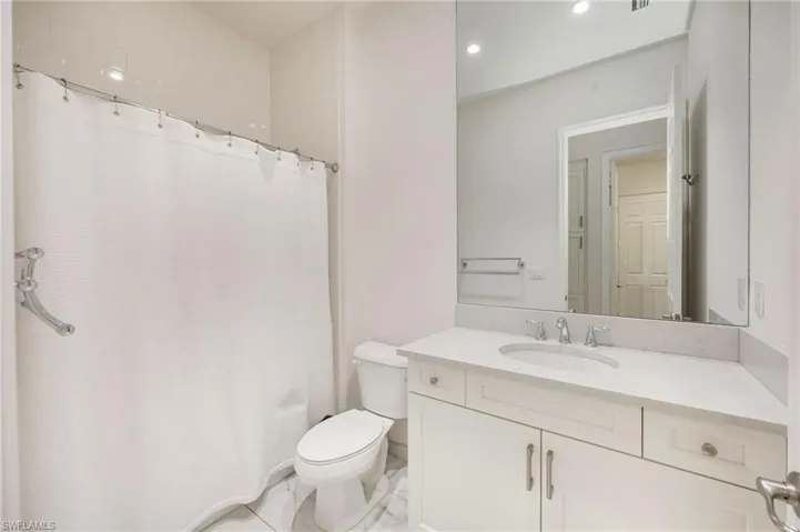 Bathroom featuring vanity, a shower with curtain, and recessed lighting