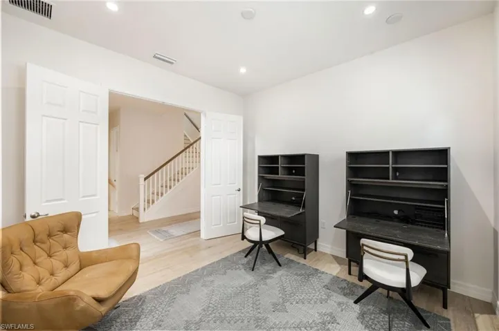 Bedroom featuring light wood-type flooring, a ceiling fan, a tray ceiling, and recessed lighting
