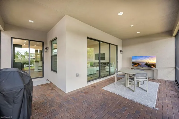 View of patio featuring a grill and outdoor dining space