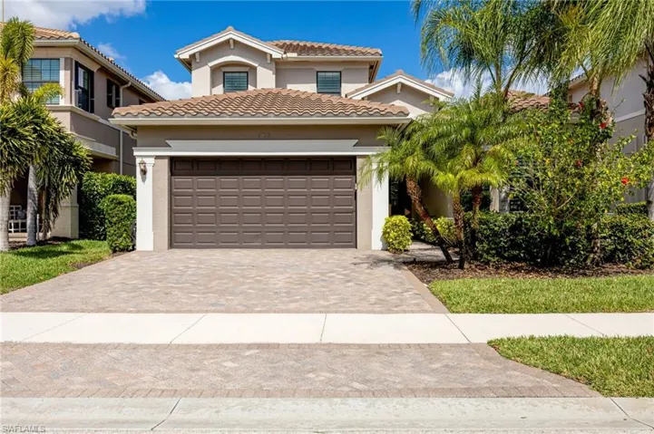 Mediterranean / spanish home with stucco siding, decorative driveway, a garage, and a tile roof