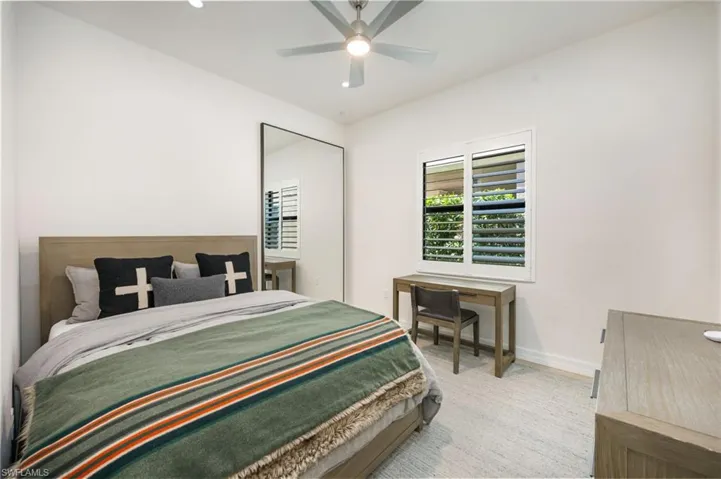 Bedroom featuring a spacious closet, a ceiling fan, light wood-style flooring, and recessed lighting