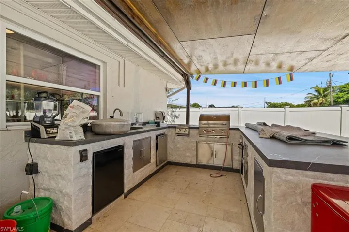 View of patio featuring exterior kitchen and area for grilling