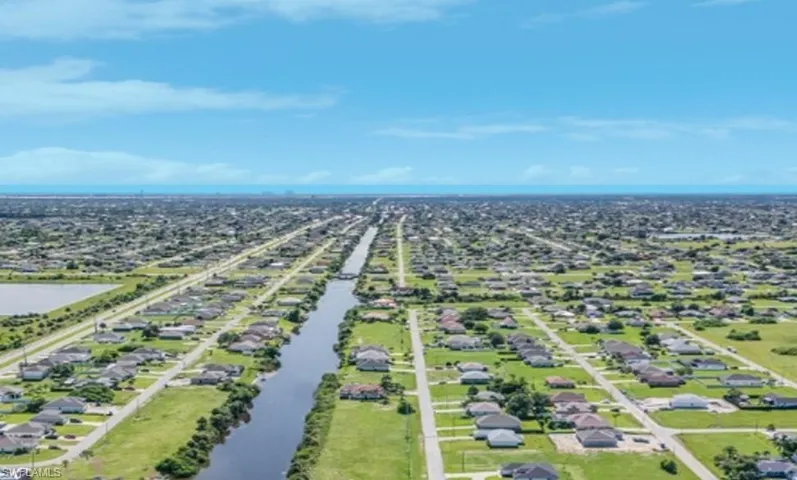 Drone / aerial view with a water view and a residential view
