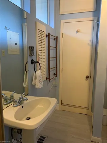 Bathroom featuring light wood finished floors and electric panel