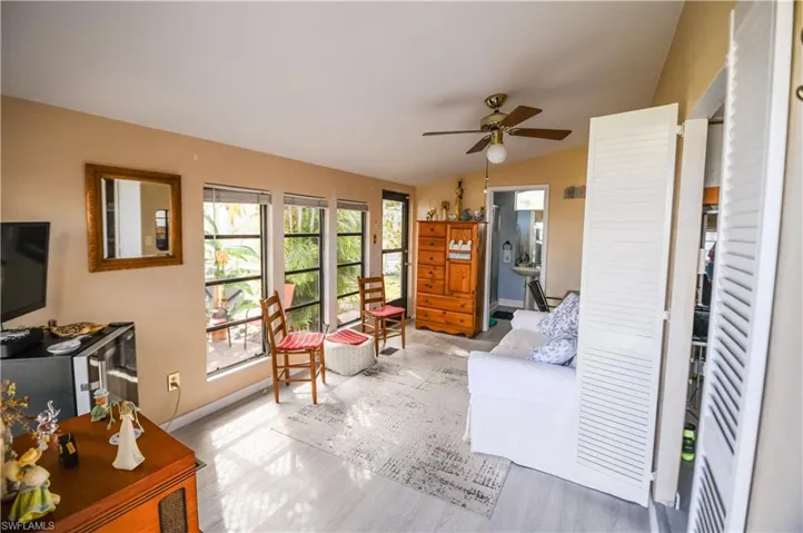 Living area featuring lofted ceiling and ceiling fan
