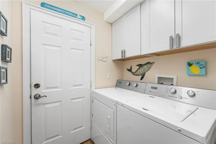 The laundry room provides additional storage space for convenience.