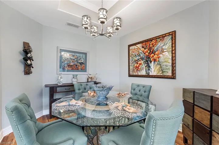 Charming dining area featuring a tray ceiling.