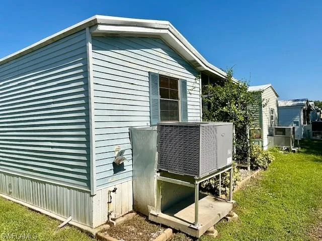 View of side of property featuring a yard