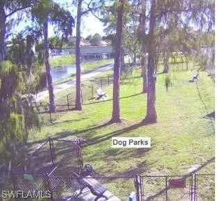 View of property's community featuring a water view and a yard