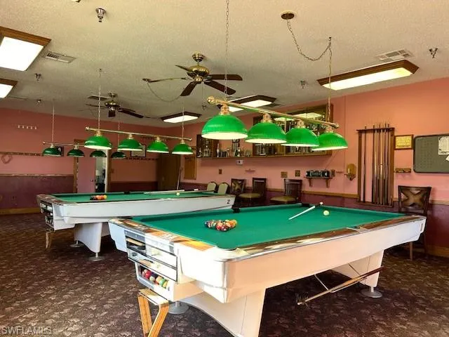 Recreation room featuring ceiling fan, pool table, and a textured ceiling