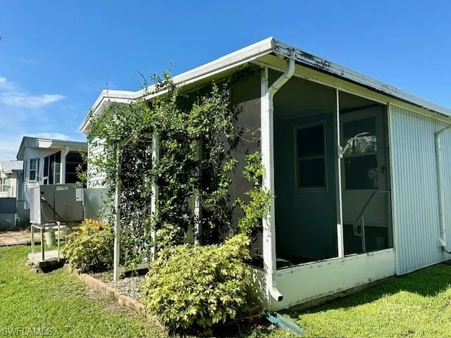 View of side of property with a yard