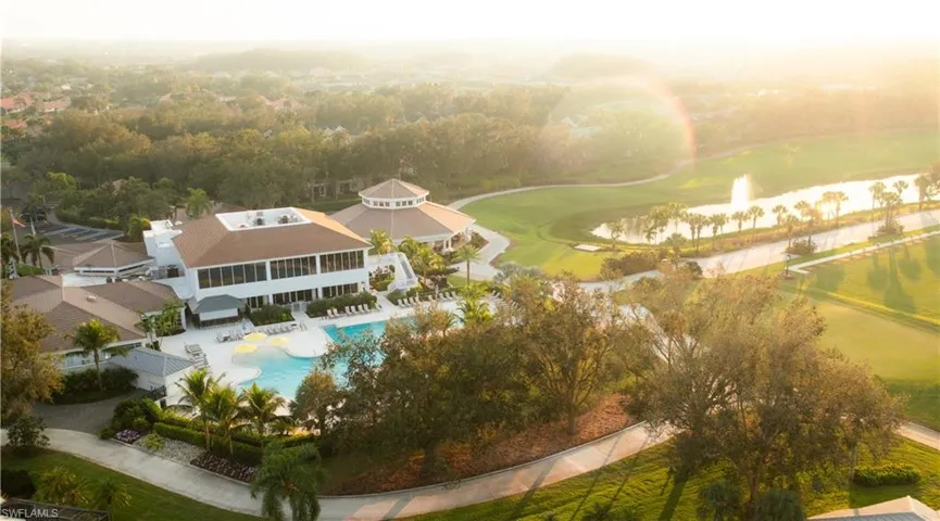 Extensive golf course with water features, expansive clubhouse, multiple swimming pools, and surrounding mature landscaping