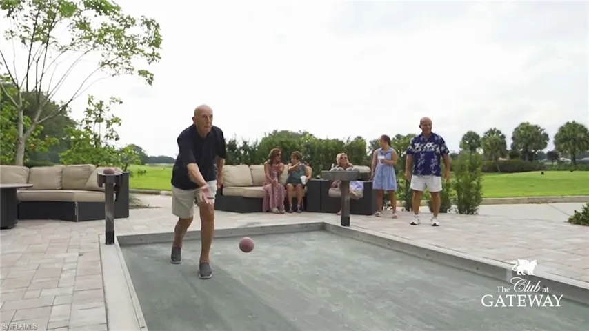 Bocce ball court with paver surround and outdoor lounge seating