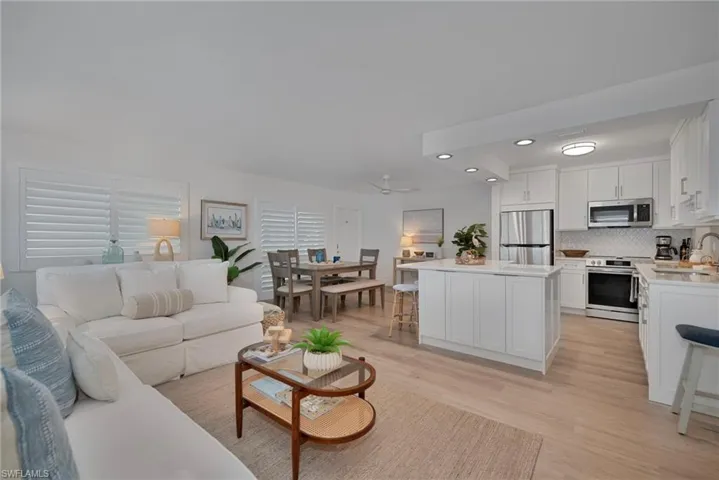 Living area with light wood finished floors, recessed lighting, and ceiling fan