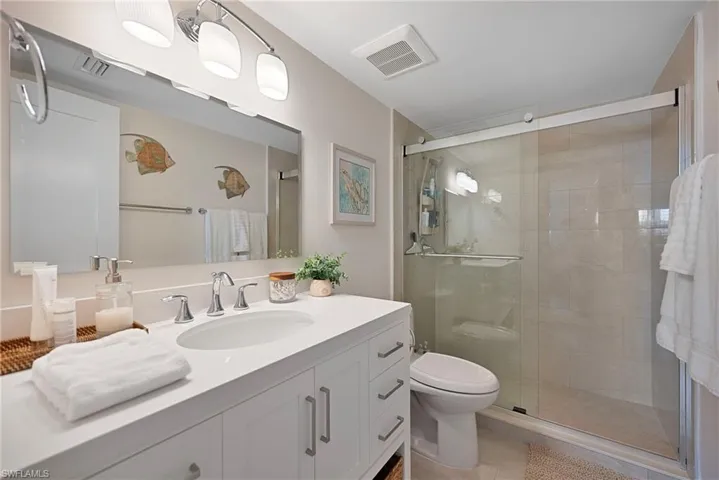 Bathroom featuring vanity, a stall shower, and light tile patterned floors
