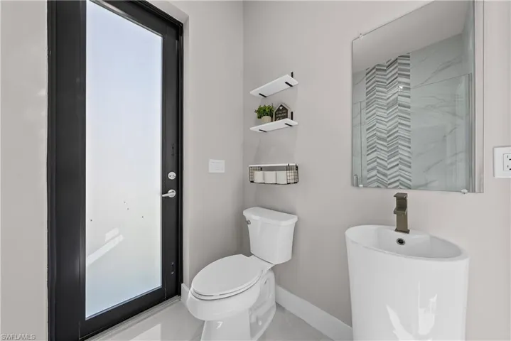 Bathroom featuring toilet and baseboards