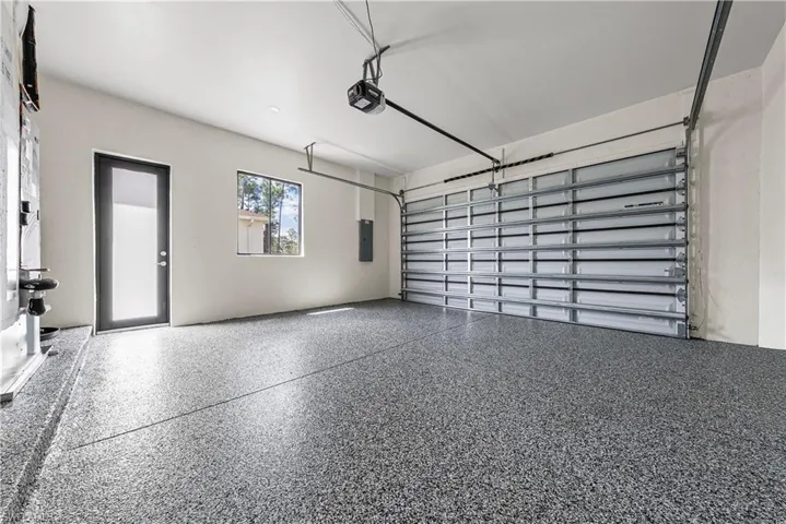 Garage with electric panel and a garage door opener