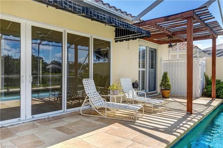 Lanai showing Awning and Pergola and Hurricane Sliders and Pool