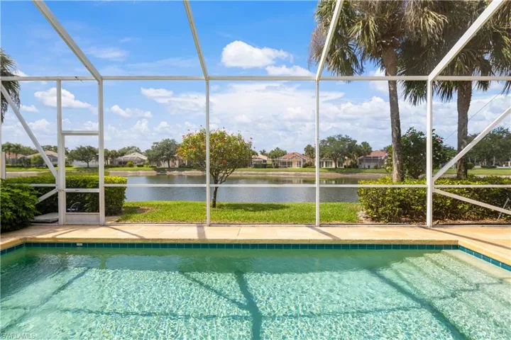 Outdoor pool with a lanai, a water view, Awning and Pergola