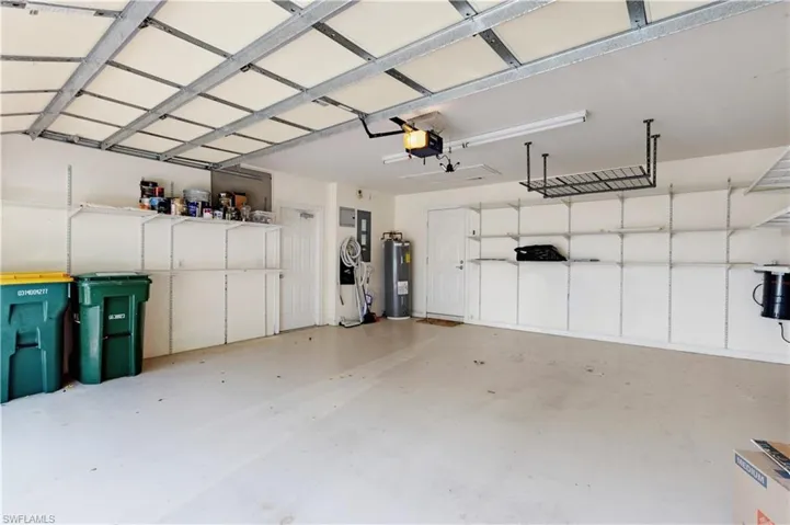 Garage with a garage door opener and electric water heater and Built in House Vacuum