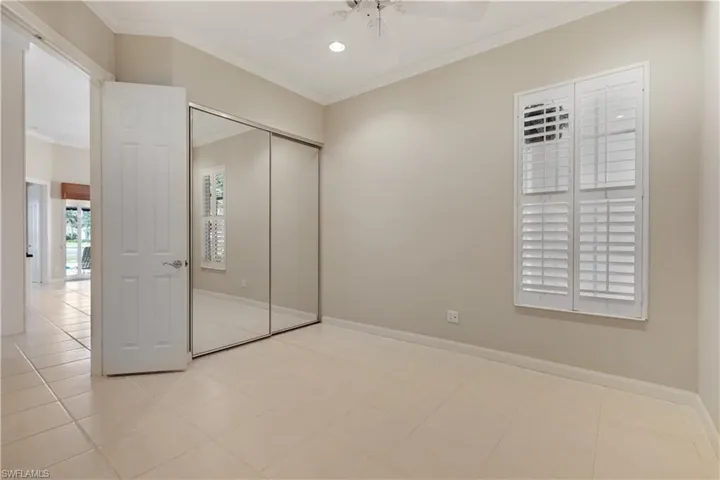 2nd bedroom with ornamental molding, baseboards, a closet, a ceiling fan, recessed lighting and plantation shutters