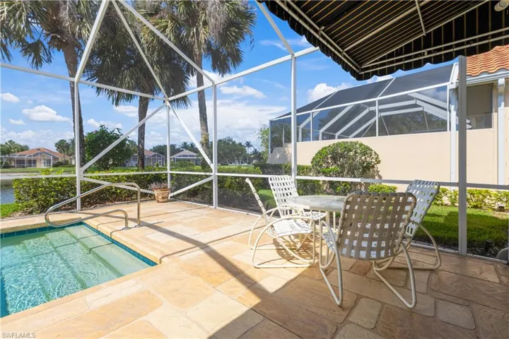 Swimming pool with a lanai, a patio area, and outdoor dining area w/ Awning and Pergola