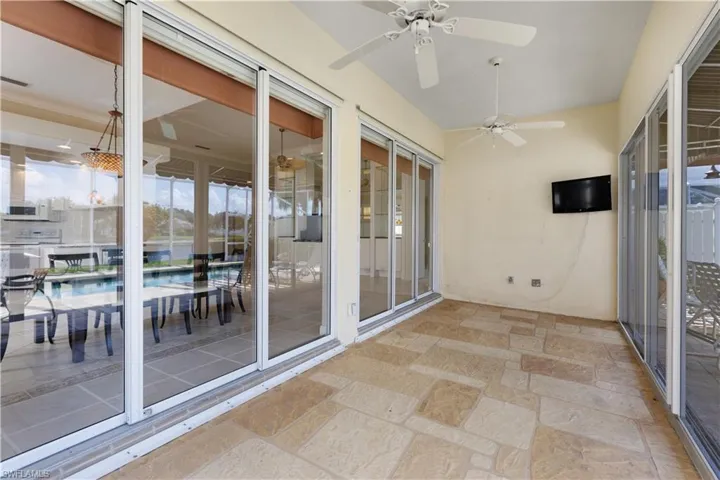Unfurnished sunroom with stone tile floors