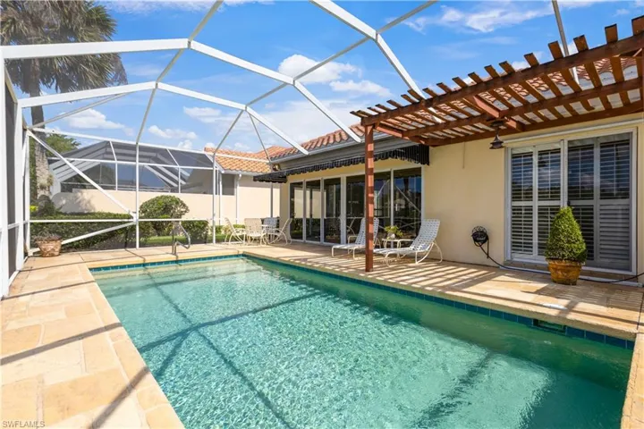 Outdoor pool with a patio, a pergola, and a lanai