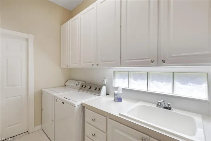 Laundry area with separate washer and dryer and cabinet space