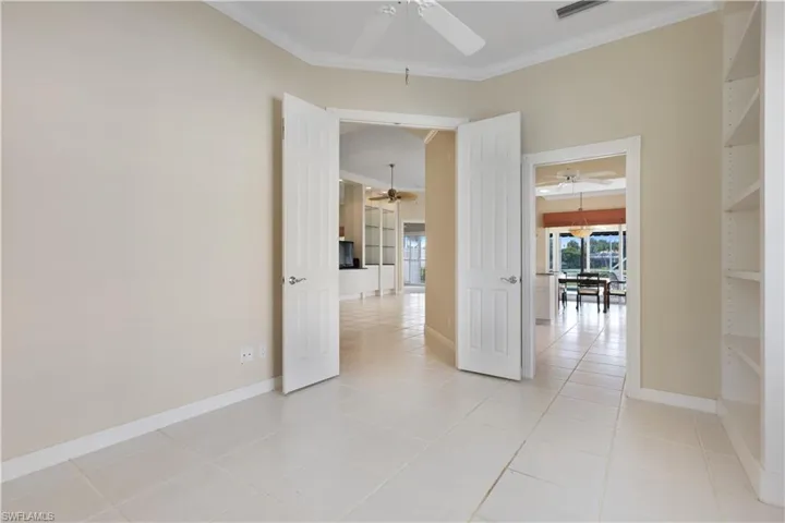 Master Bedroom w/ French Doors connecting to LR and Hallway of Closets to Master Bath
