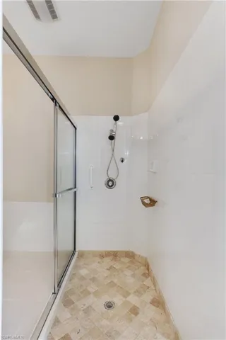 MB Full bathroom featuring a shower stall