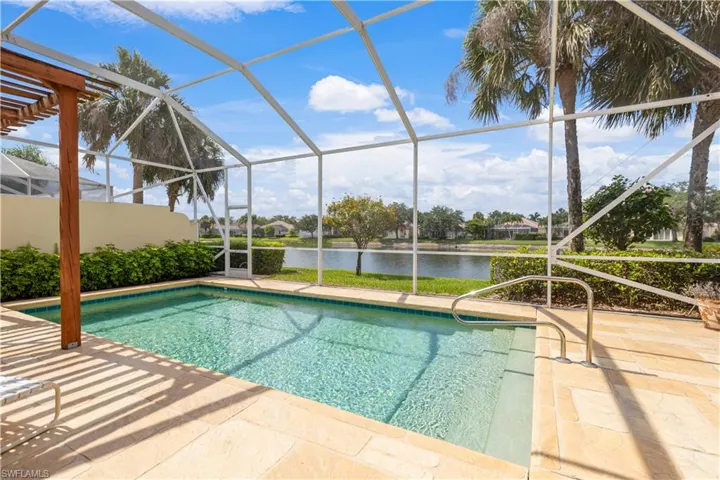 Swimming pool featuring a water view, a patio, and glass enclosure, Awning and Pergola