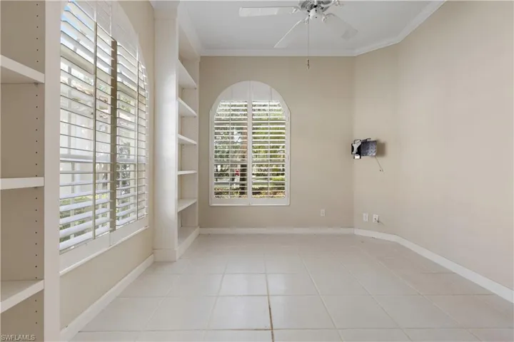 Den room featuring ceiling fan, crown molding, and baseboards and Plantation Shutters