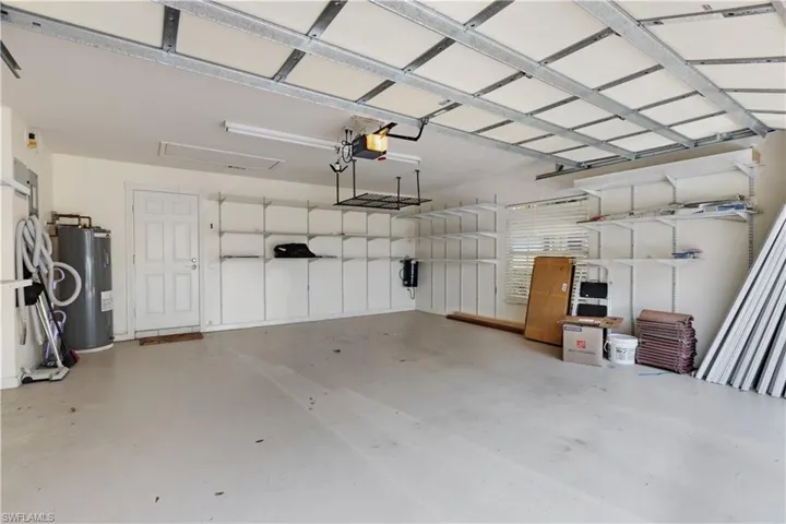 Garage with water heater and a garage door opener