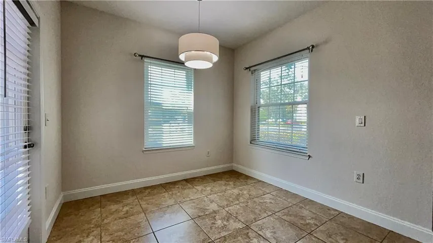 Spare room featuring a healthy amount of sunlight and light tile patterned floors